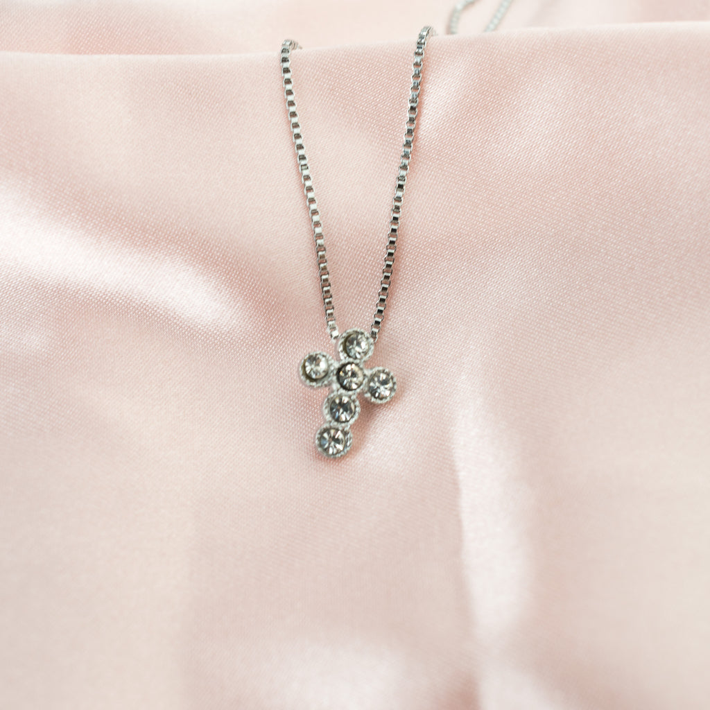 Cruz de círculos plateada